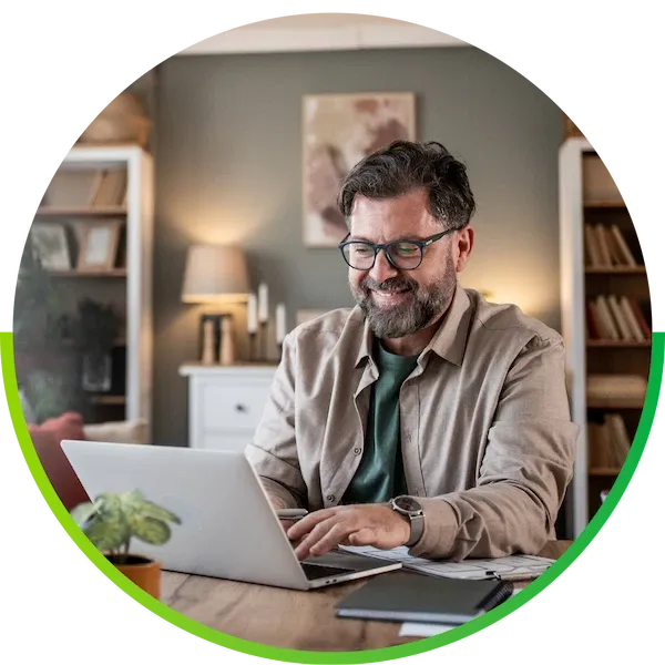 Smiling mature man working remotely